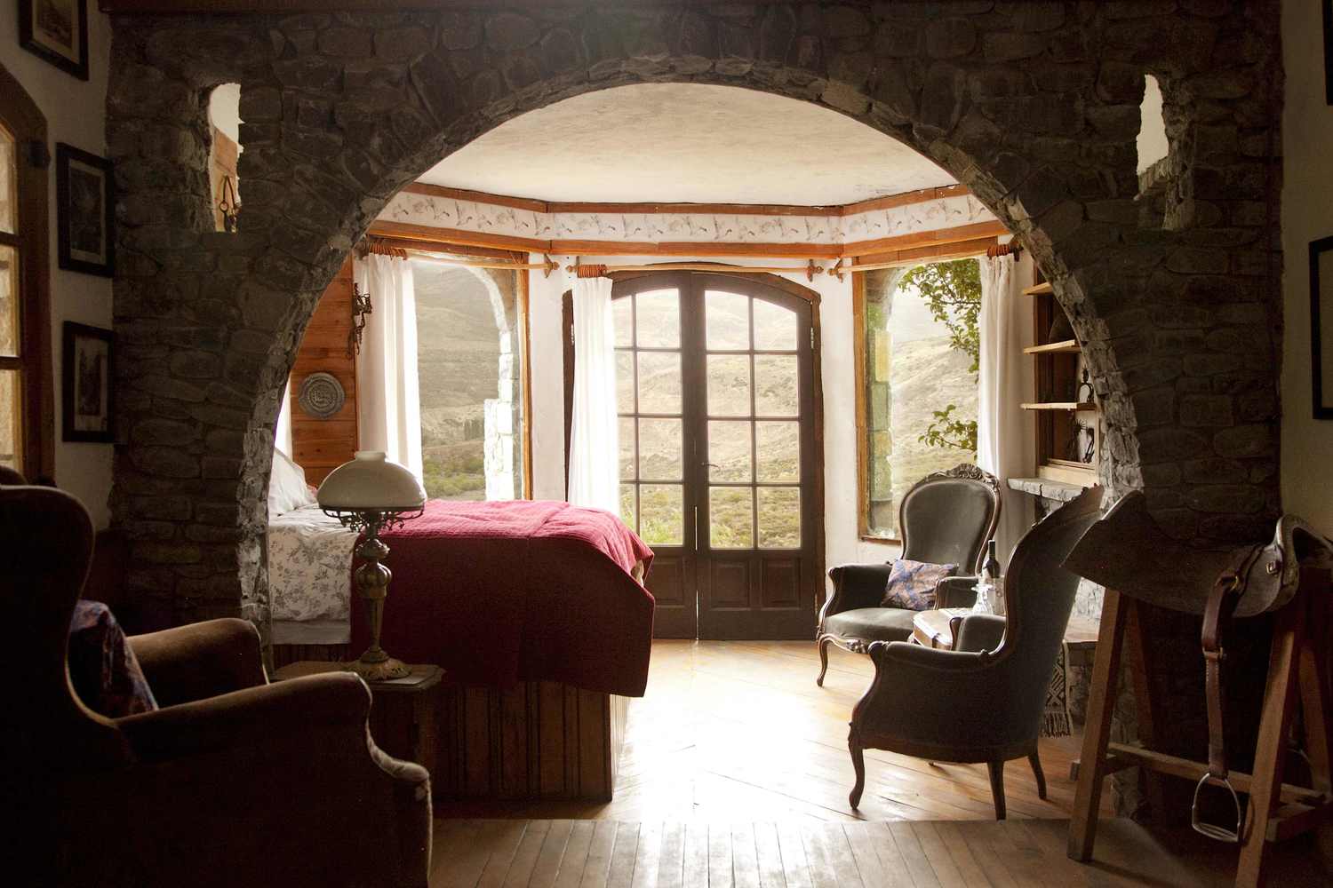 Image of the handcrafted stone arch and french doors in the Castle Room at Estancia Ranquilco