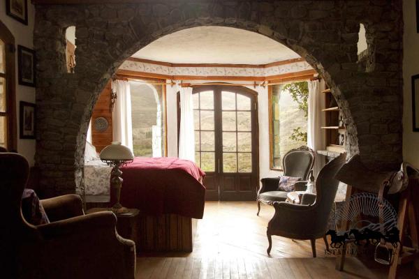 Image of the handcrafted stone arch and french doors in the Castle Room at Estancia Ranquilco